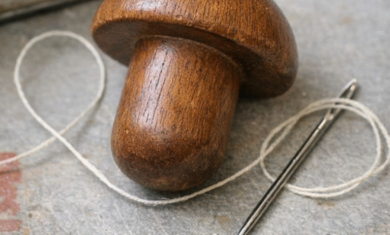 Found this smooth wooden object in an old sewing tin. Shaped like a mushroom but the handle is too short to be a pestle.